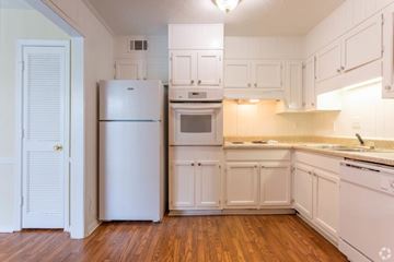 East Point apartment for rent - A white kitchen with wood floors and white appliances.