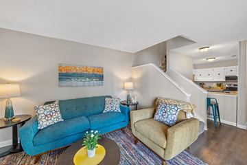 Milledgeville apartment for rent - A living room with a blue couch and a yellow coffee table.