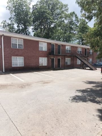 Austell apartment for rent - A red brick building with a parking lot in front.