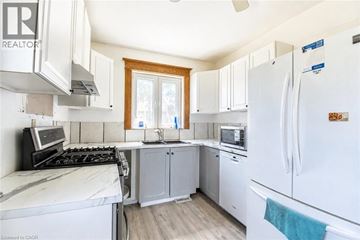 Cambridge apartment for rent - A kitchen with white appliances and wooden cabinets.
