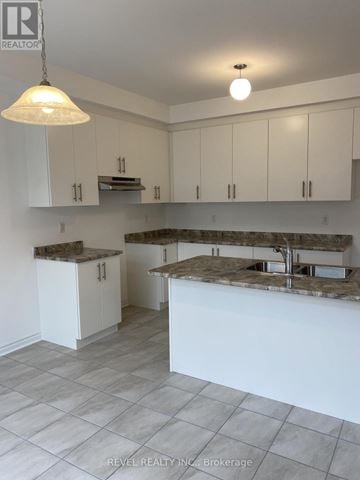Collingwood apartment for rent - A kitchen with white cabinets and a marble countertop.