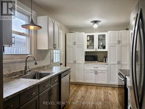 Shelburne apartment for rent - A kitchen with white cabinets and a stainless steel refrigerator.