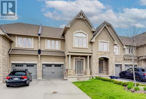 Oakville (Bc Bronte Creek) townhouse for rent - A large, well-maintained house with a car parked in front.