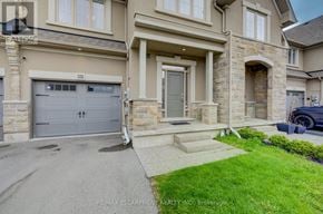 Oakville (Bc Bronte Creek) townhouse for rent - A house with a grey garage door is for sale.