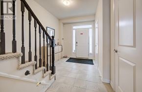 Oakville (Bc Bronte Creek) townhouse for rent - A hallway with a staircase and a door at the end.