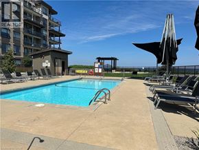 Grimsby condo for rent - A pool area with a slide and sun loungers.