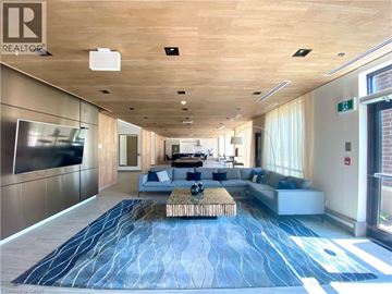Grimsby condo for rent - A spacious living room with a long blue rug and a wooden ceiling.