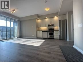 Grimsby condo for rent - A spacious kitchen with wooden flooring and modern appliances.