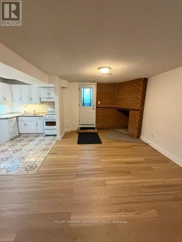 Toronto (Highland Creek) apartment for rent - A small white kitchen with a sink and stove.
