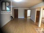 Toronto (Highland Creek) apartment for rent - A room with a wooden floor and a sign that says REALTOR.