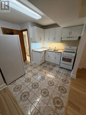 Toronto (Highland Creek) apartment for rent - A white toilet sits next to a white cabinet in a bathroom.
