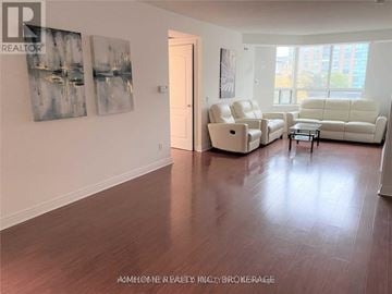 Toronto (Bendale) condo for rent - A living room with a white sofa and two chairs.