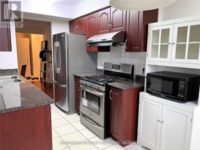 Toronto (Bendale) condo for rent - A kitchen with a refrigerator, oven, and microwave.