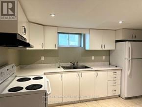 Richmond Hill (Crosby) apartment for rent - A kitchen with white cabinets and a white refrigerator.