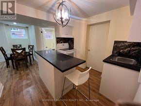 Newmarket (Armitage) apartment for rent - A kitchen with a black countertop and white cabinets.