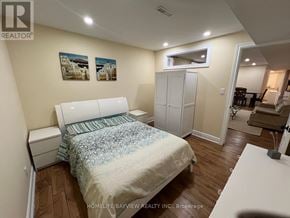 Newmarket (Armitage) apartment for rent - A bedroom with a bed, nightstand, and a cabinet.