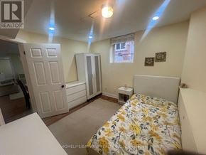 Newmarket (Armitage) apartment for rent - A bedroom with a bed, dresser, and window.