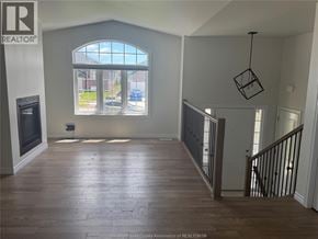 Lakeshore apartment for rent - A room with a large window and wooden flooring.