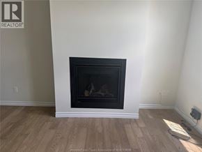 Lakeshore apartment for rent - A fireplace in a room with wooden flooring and white walls.