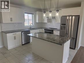 Lakeshore apartment for rent - A kitchen with a granite countertop and stainless steel appliances.