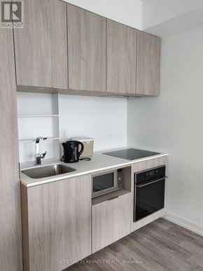 Toronto (Church-Yonge Corridor) condo for rent - A modern kitchen with a sink, stove, and oven.