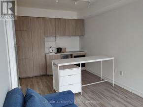 Toronto (Church-Yonge Corridor) condo for rent - A kitchen with a white table and blue couch.