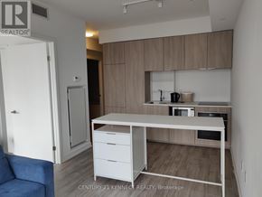 Toronto (Church-Yonge Corridor) condo for rent - A realtor office with a desk and a blue chair.