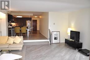 Toronto (Bay Street Corridor) condo for rent - A living room with a couch, a television, and a picture frame on the wall.