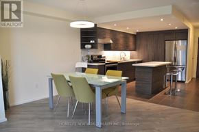 Toronto (Bay Street Corridor) condo for rent - A modern kitchen with a dining table and chairs.