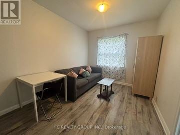Toronto (Newtonbrook East) apartment for rent - A living room with a couch, chair, and table.