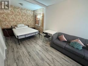 Toronto (Newtonbrook East) apartment for rent - A bedroom with a bed, a couch, and a chair.