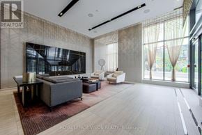 Toronto (Casa Loma) condo for rent - A spacious living room with a grey sofa set and a large window with curtains.