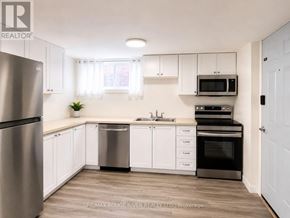 Welland (Prince Charles) apartment for rent - A kitchen with white cabinets and a stainless steel refrigerator.