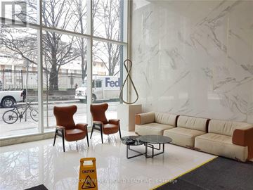 Toronto (Church-Yonge Corridor) condo for rent - A living room with a sofa, chairs, and a table in front of a large window.