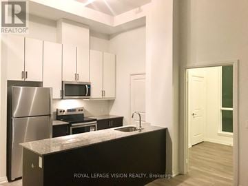 Toronto (Woburn) condo for rent - A kitchen with a refrigerator, microwave, oven and sink.