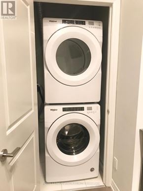 Toronto (Woburn) condo for rent - A white washing machine and dryer in a small laundry room.