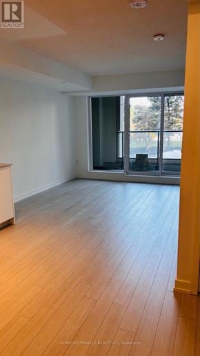 Toronto (Humber Heights) condo for rent - A room with wooden flooring and a sliding glass door.