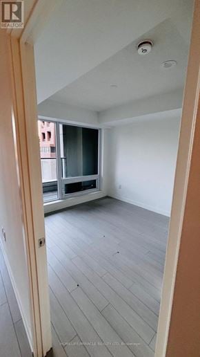 Toronto (Humber Heights) condo for rent - A room with a window and a wooden floor.
