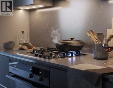 Burnaby apartment for rent - A modern kitchen with a stove and a pot on it.