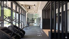 Burnaby apartment for rent - A gym with treadmills and a sign that says "Slate".