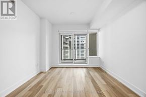 Markham (Unionville) condo for rent - A room with a large window and wooden flooring.