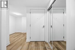 Markham (Unionville) condo for rent - A white door with a glass panel is in a room with wooden floors.