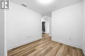 Markham (Unionville) condo for rent - A room with wooden flooring and white walls.