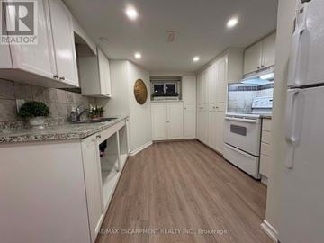 Hamilton (Sunninghill) apartment for rent - A kitchen with white cabinets and a wooden floor.