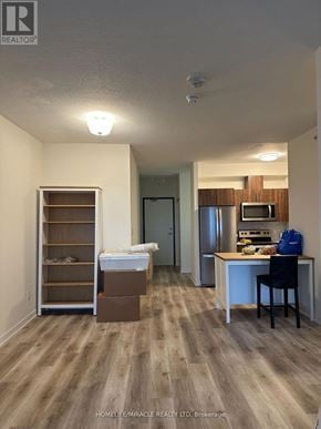 Waterloo condo for rent - A room with a desk, chair, and a crib in it.