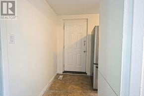 Hamilton (Corktown) duplex for rent - A white door is in a white hallway.