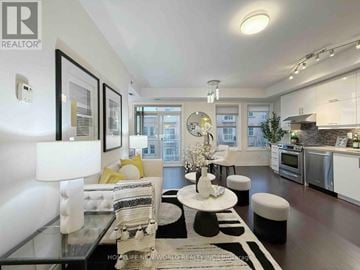 Markham (Cathedraltown) condo for rent - A modern living room with a glass coffee table and a white sofa.