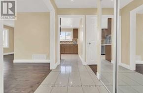 Brampton (Madoc) apartment for rent - A spacious room with beige walls and a wooden floor.