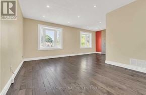 Brampton (Madoc) apartment for rent - A spacious room with wooden flooring and a large window.