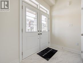 Brampton (Northwest Brampton) townhouse for rent - A room with a black doormat and a door with a window.